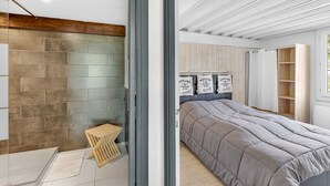 A modern bedroom with a large bed, a wooden headboard, and a built-in wardrobe. - Holiday Home 'Les Iris' with Mountain View, Private Terrace and Wi-Fi (La Robine-sur-Galabre)