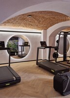 A gym with treadmills, a weight machine, and a mirror.