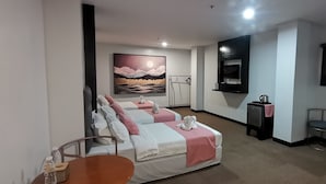 A hotel room with two beds, a TV, a small table, and a painting on the wall. - Belvilla Angeles Pampanga Near Clark International Airport Formerly Boss Hotel (Angeles City)