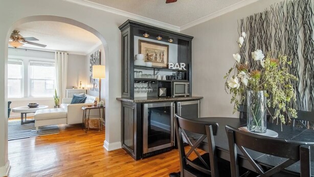 A modern kitchen with a built-in microwave and a bar area.