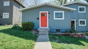 A two-story building with a red door, a small front porch, and a number '4029' on the side.