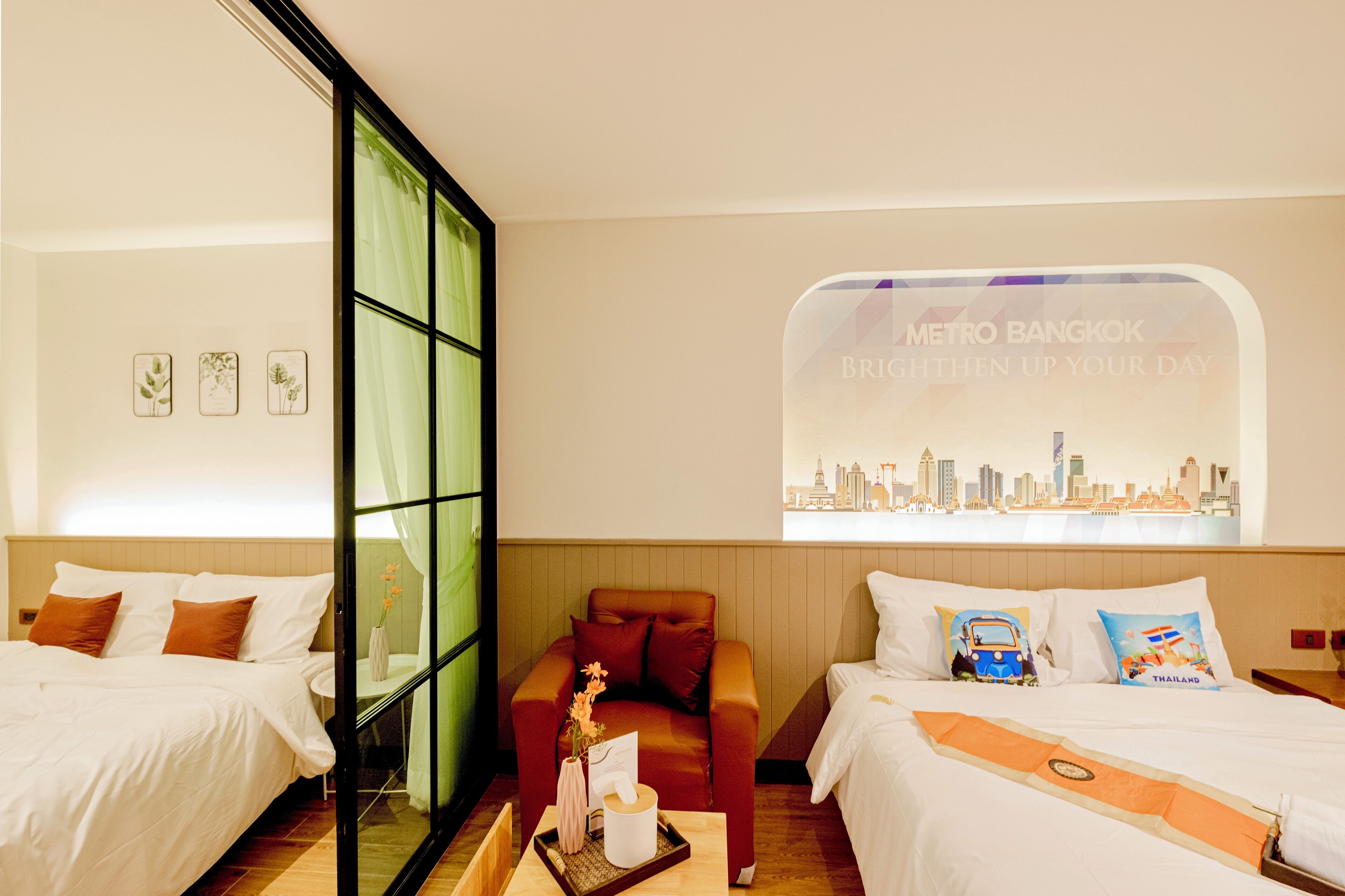 A hotel room with two beds, a cityscape view, and a window with curtains.