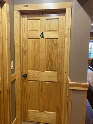 A wooden door with a number '4' above it, indicating a room number.