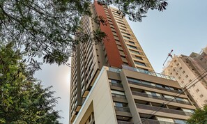 A high-rise building with multiple floors, large windows, and balconies. - HMO - Full-length Studios in Building c/ Pool (São Paulo)