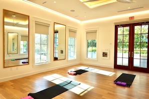 A room with wooden flooring, large mirrors, and exercise mats. - Renovated Guest Home w/Designer Detail, 125 Ft. to Beach in Seaside! +2 Bikes (Santa Rosa Beach)