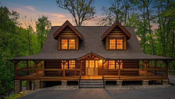 A log cabin with a central entrance, two side windows, and a porch. - Oakmont Lodge: 8 acres•HotTub•free tkts•pool table (Gatlinburg)