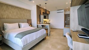 A modern hotel room with a large bed, a desk, a chair, and a television. - w Luxurious Loft w Balcony in Crespo (Cartagena)
