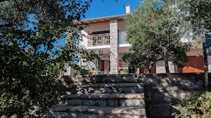 A stone staircase leading to a two-story building with a balcony. - Terra Ionian (Pyrgos)