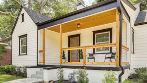 A single-story house with a covered porch, a brick pathway, and small potted plants. - 4 Mi to Intl Soccer & Dtwn Fun: Modern ATL Home (Atlanta)