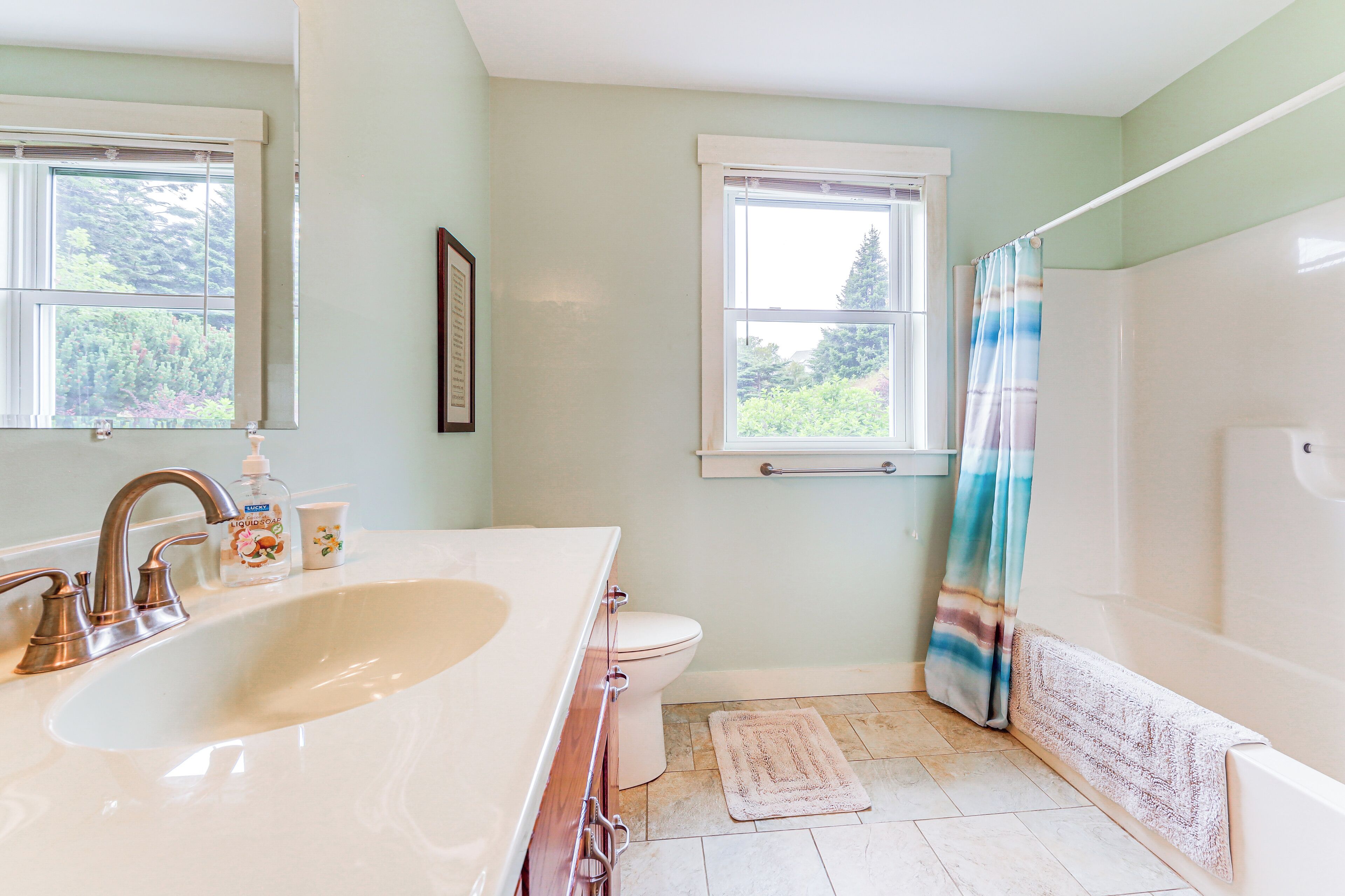 A bathroom with a white sink, a toilet, and a bathtub.