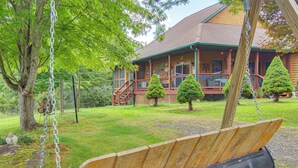 A wooden swing set in a backyard with a house in the background. - Wraparound Porch w/ Views: Blue Ridge Mtn Gem! (Bakersville)