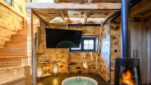 A wooden cabin interior with a fireplace, a small pool, and a television. - A-home Villa Private Pool Relaxing Hottub Oasis (Heraklion)