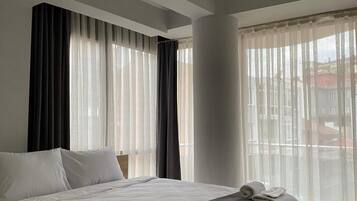 Desk, laptop workspace, blackout curtains, iron/ironing board