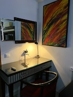 Desk, laptop workspace, blackout drapes, iron/ironing board