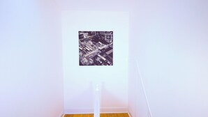 A hallway with a wooden floor and a framed black and white photograph on the wall. - Triple Room in Kensington with Ensuite Bathroom and Workspace (Kensington)