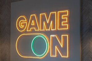 A neon sign with the words "GAME ON" in a modern, illuminated style.