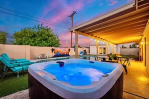 A hot tub under a covered area with a mural, outdoor seating, and a pool. - Scottsdale Arizona - Pool, Hot Tub, & Mini Golf! Perfect for family and groups! (Scottsdale)