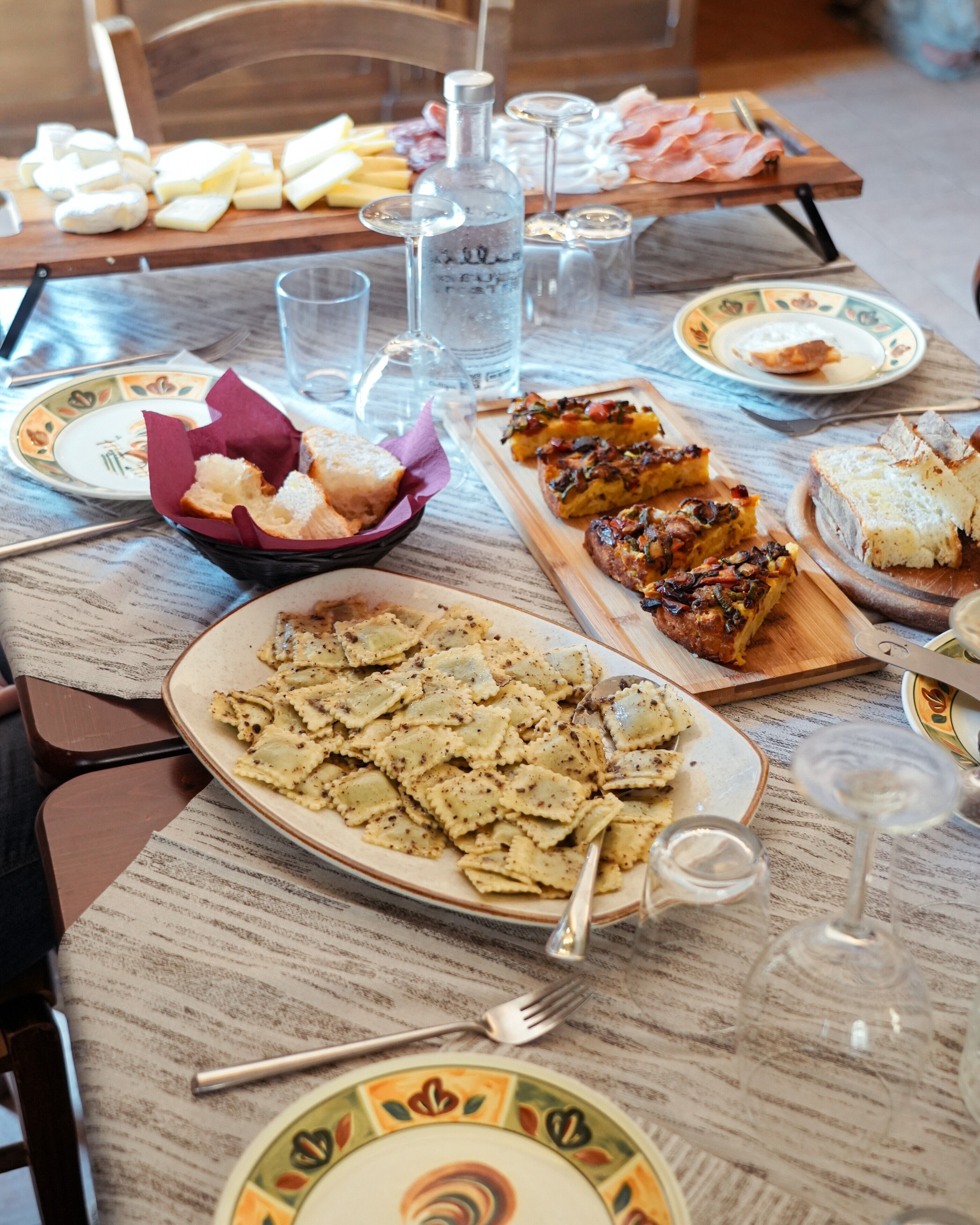 A table set with various dishes, glasses, and cutlery.