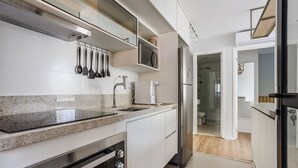 A modern kitchen with granite countertops, stainless steel appliances, and a built-in microwave.
