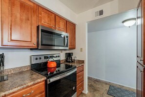 Fridge, coffee/tea maker, highchair, cookware/dishes/utensils