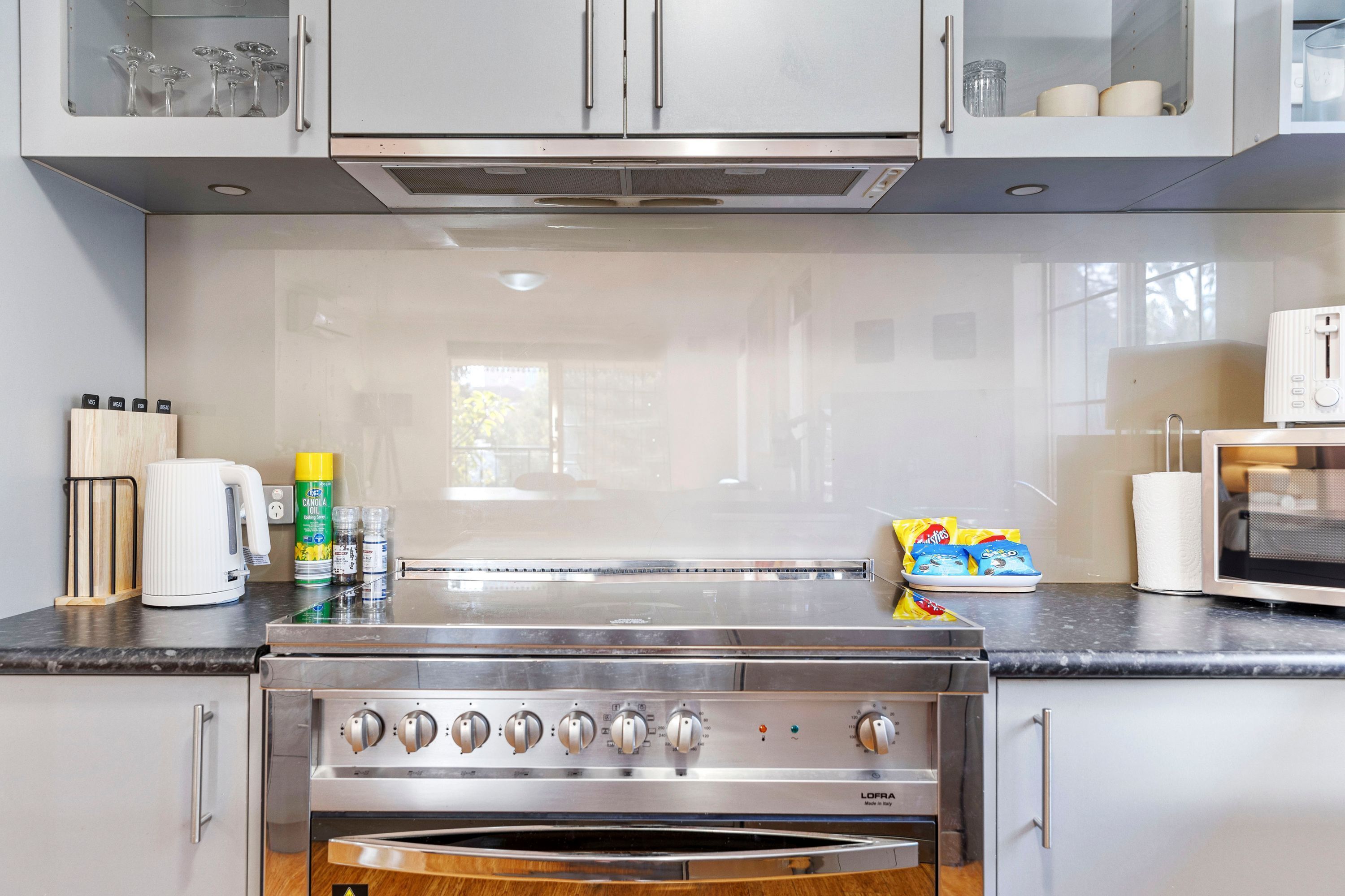 A kitchen with stainless steel appliances, a microwave, and a toaster.