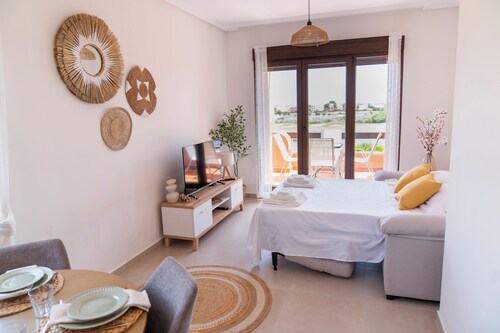 Sunny apartment overlooking pool, golf course and sea.