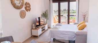 Sunny apartment overlooking pool, golf course and sea.