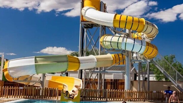 A water park with multiple water slides and a swimming pool.