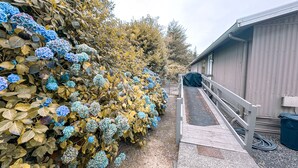 A pathway leading to a building with a covered outdoor area.