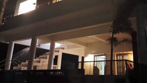 Ein mehrgeschossiges Gebäude mit einem Balkon und einer Treppe, die zu dem oberen Stockwerk führt.