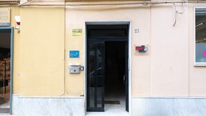 A building entrance with a door, a sign indicating 'VENDESI,' and a small window with a pink sign. - Apartment 'Civico 23 Matera' with Balcony, Wi-Fi and Air Conditioning (Matera)