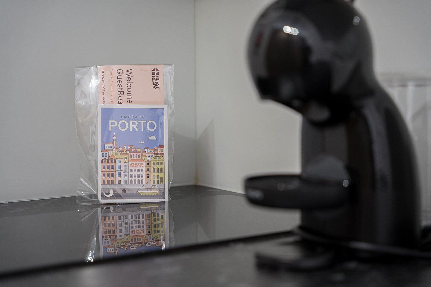 A plastic bag with a 'Welcome to Porto' sign on a reflective surface.