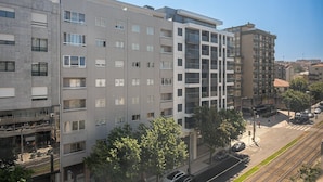Un immeuble résidentiel à plusieurs étages, doté d’une architecture moderne, de balcons et de grandes fenêtres.