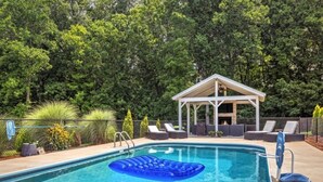 A swimming pool with lounge chairs and a gazebo. - Charming 3-bedroom farmhouse with Pool &Hot Tub in Asheville Fletcher area (Fletcher)