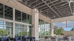 A spacious outdoor area with a large chessboard, seating arrangements, and a modern building with large windows. - Toast to the City/ ATL High-Rise with Bar & Views (Atlanta)
