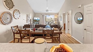 A dining area with a table, chairs, and a view of the outdoors.