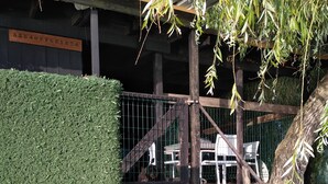 A staircase leading up to a wooden deck with a metal railing, surrounded by greenery and a tree. - In the midst of wildlife and marshland, a ton of thrills and chills  (Vendays-Montalivet)