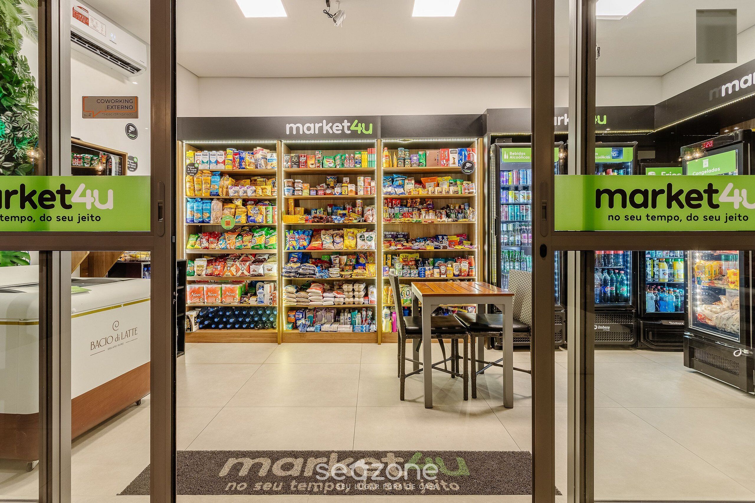 A supermarket interior with shelves stocked with various products, a seating area, and a 'market4u' sign.
