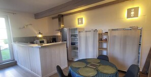 A compact kitchen with a central island, built-in microwave, and overhead lighting.