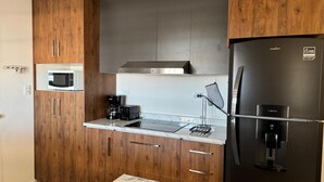 A modern kitchen with wooden cabinets, a black refrigerator, a microwave, and a coffee maker. - House for 8 with Private Pool (San Carlos)