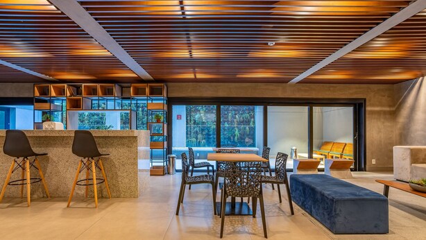 A modern interior with a bar area, seating, and a view through large windows. - Beautiful Studio 270m Oscar Freire Subway Coe0406 (São Paulo)