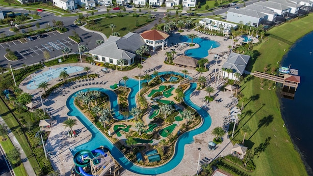 An aerial view of a resort with multiple swimming pools, a golf course, and beachfront properties. - Gorgeous 9bedroom Home Private Pool Game Theater (Kissimmee)