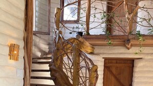 A rustic wooden staircase with a natural, tree-like design. - Solar Kaeté (Santo Amaro do Maranhão)