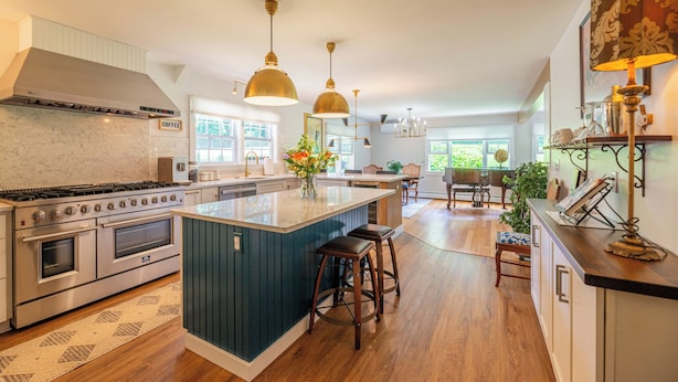 A modern kitchen with a large island, stainless steel appliances, and pendant lighting. - Modern Mountain Retreat w/ Chef’s Kitchen (Manchester)