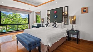 A bedroom with a large window, a bed with white bedding, a bench, a bedside table with a lamp, and a wall-mounted artwork. - Laguna Village, Two-Bedroom 138/25 Townhouse (Cherngtalay)