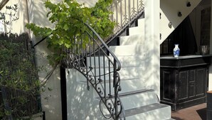 A staircase with ornate metal railings leading to a landing. - A HAVEN OF PEACE ON THE OUTSKIRTS OF PARIS (Clamart)