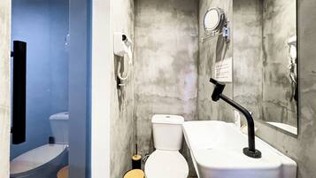 A compact bathroom with a toilet, sink, and mirror.