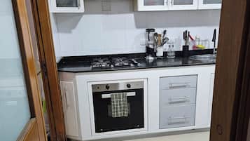 Een koelkast/vriezer, een magnetron, een oven, een kookplaat