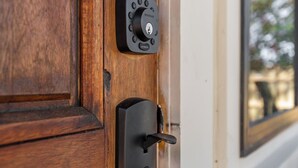 A wooden door with a modern electronic lock and a keyhole. - Missouri’s 1st Sinclair Service Station (Walnut Grove)