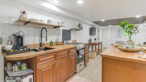 A modern kitchen with wooden cabinets, a built-in oven, and a coffee maker. - Logan Square Urban Oasis: 2 Mi to Local Hotspots! (Chicago)